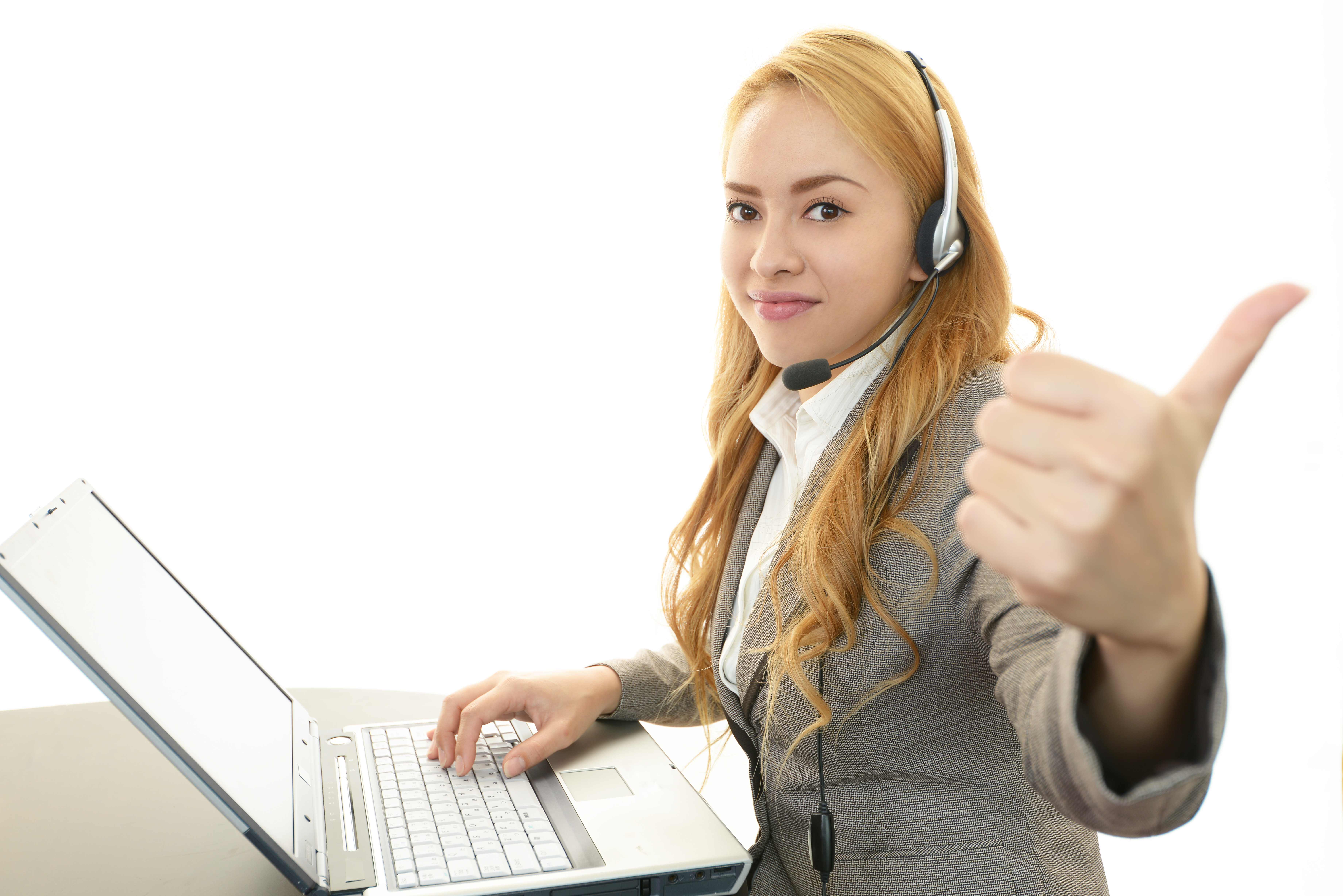 Dedicated ISA wearing a headset at a laptop giving a thumbs up